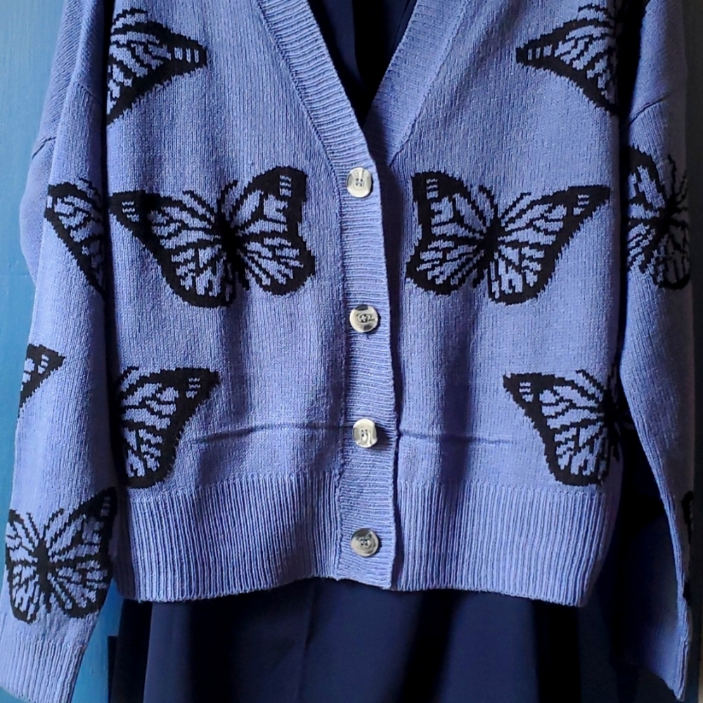 A beautiful butterfly button up pull over sweater brand new.